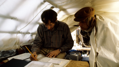 Arthur watches Tim in tent writing log
